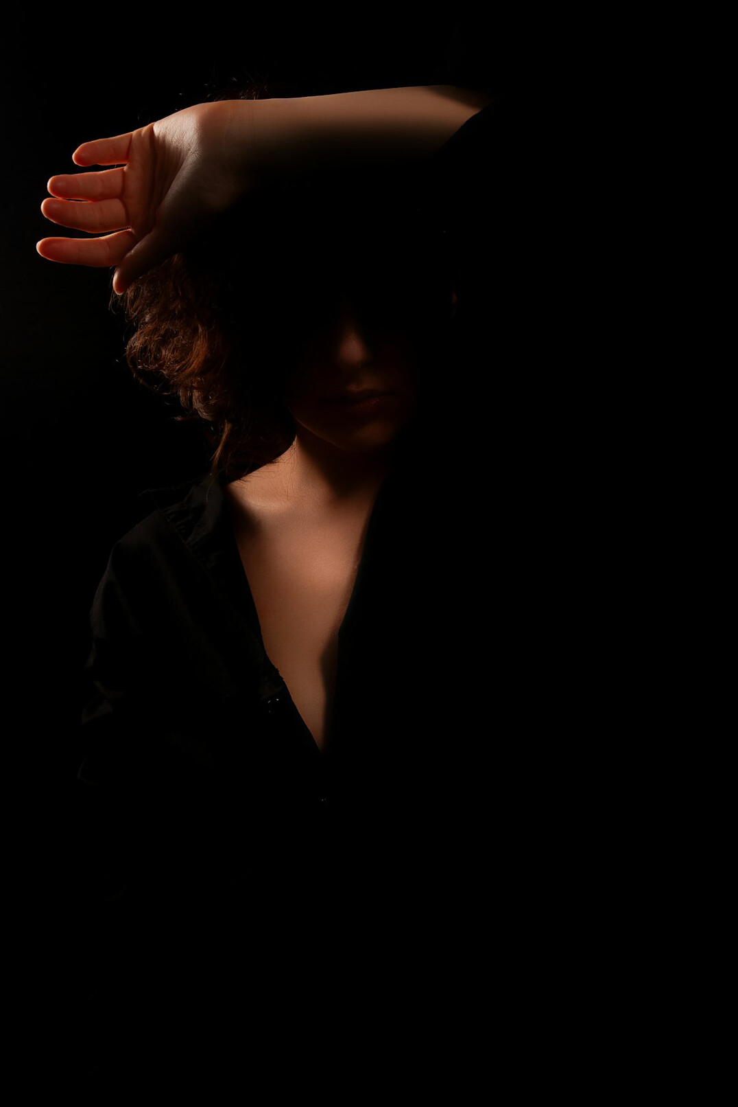 Portrait of a confident woman in a dark blazer, studio lighting